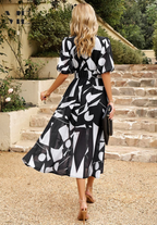 Black abstract print puff sleeve midi dress – full length walking view