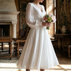 Women's classic long sleeve flowing wedding dress, side profile view