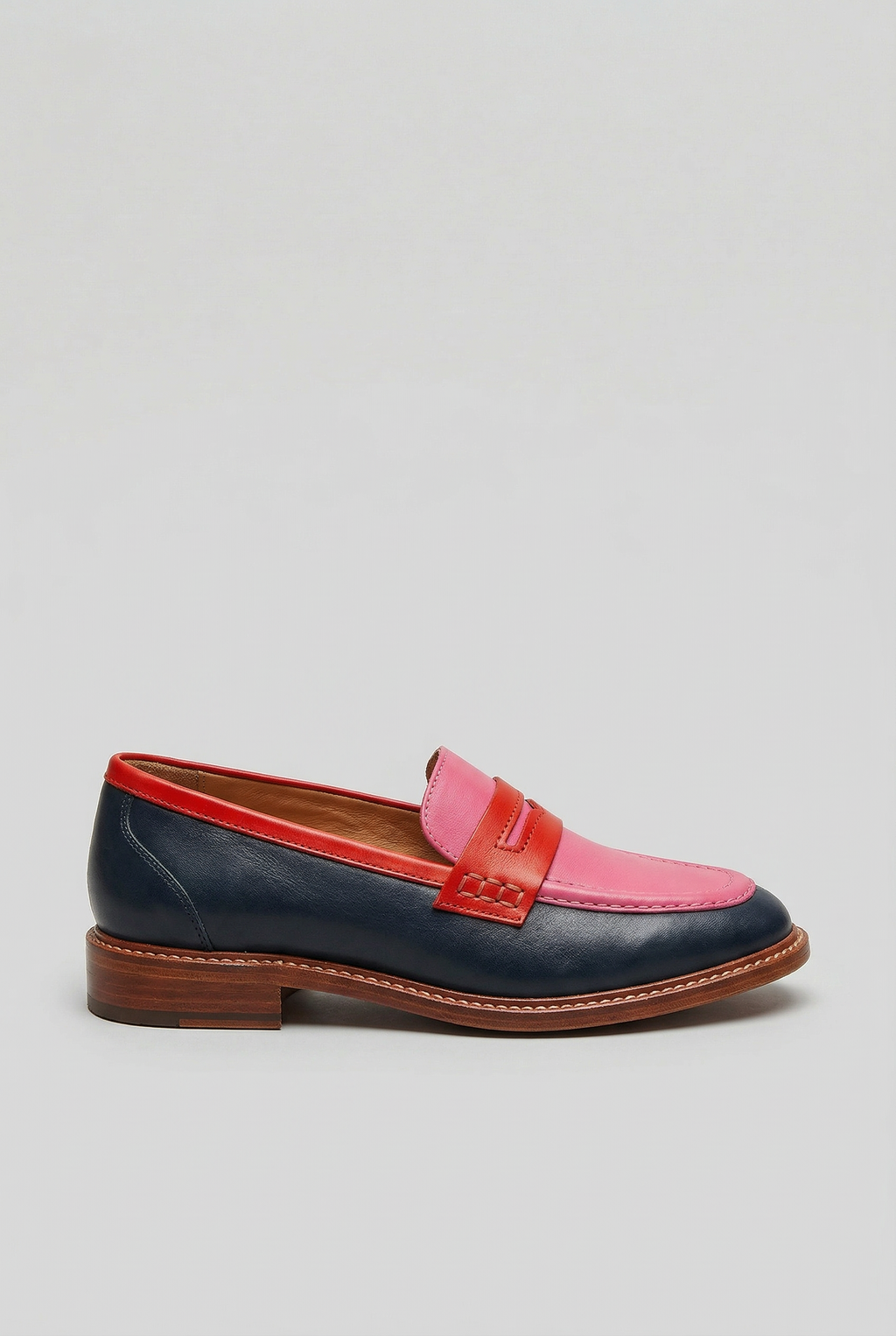 Women's two-tone penny strap loafers, side view