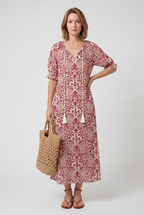 Women's flowing boho print maxi dress styled for a beach holiday