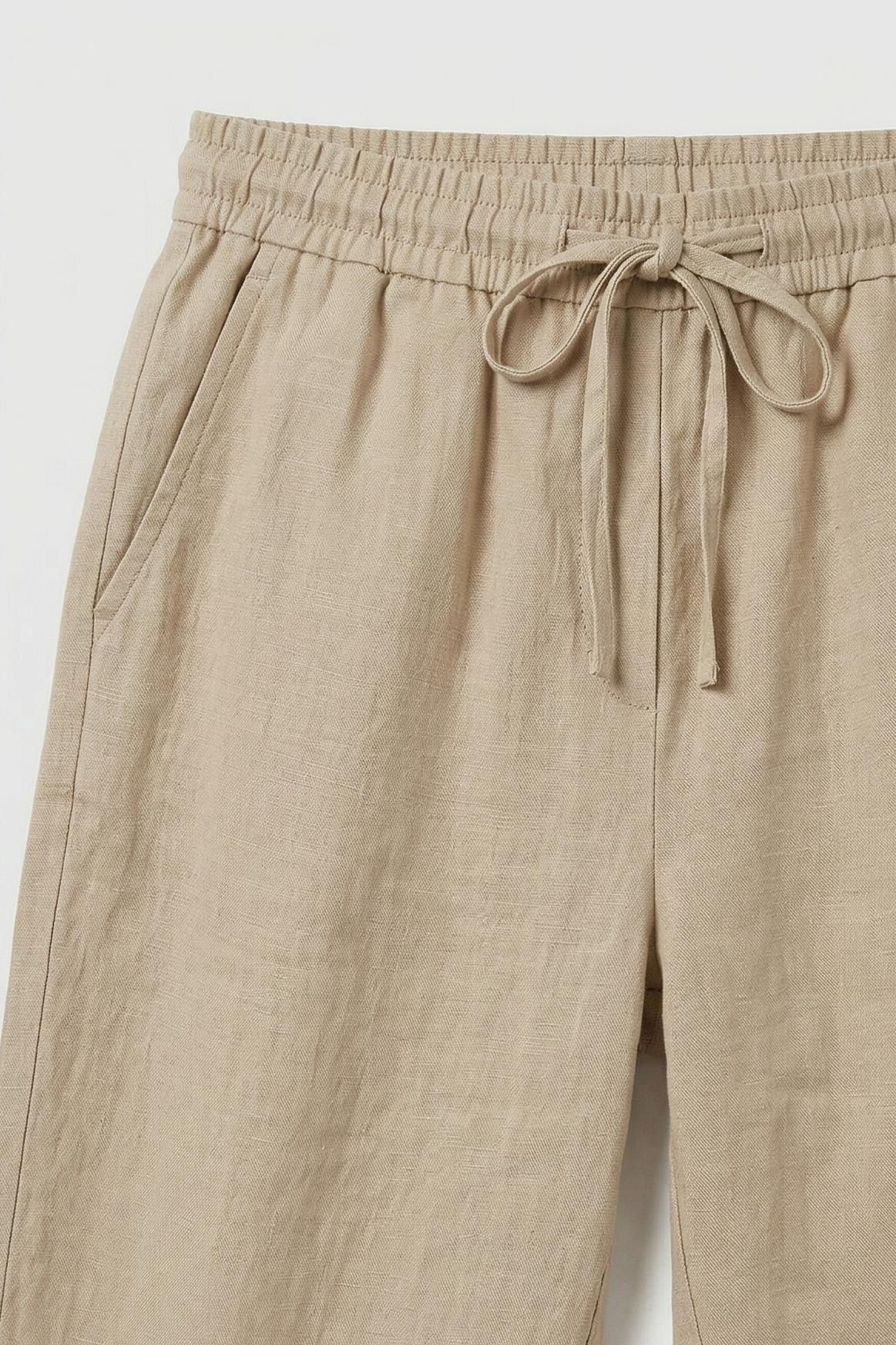 Women's roll-up linen trousers, close-up of drawstring waist detail
