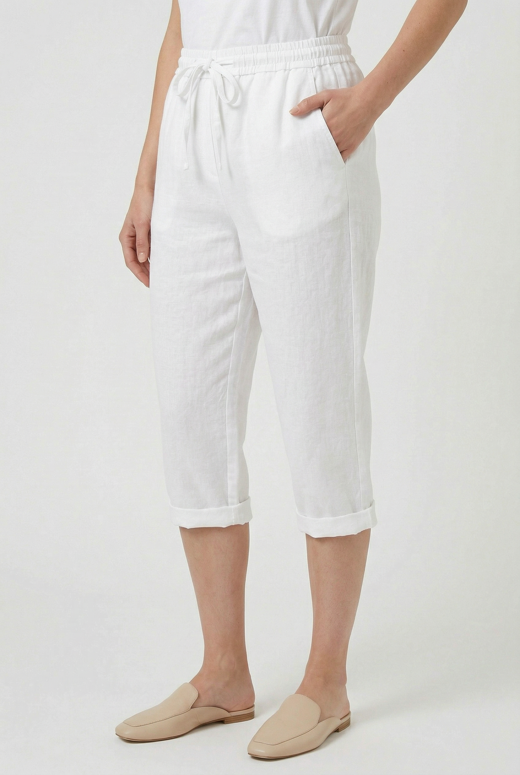 Women's linen-look roll-up trousers styled for a summer casual occasion