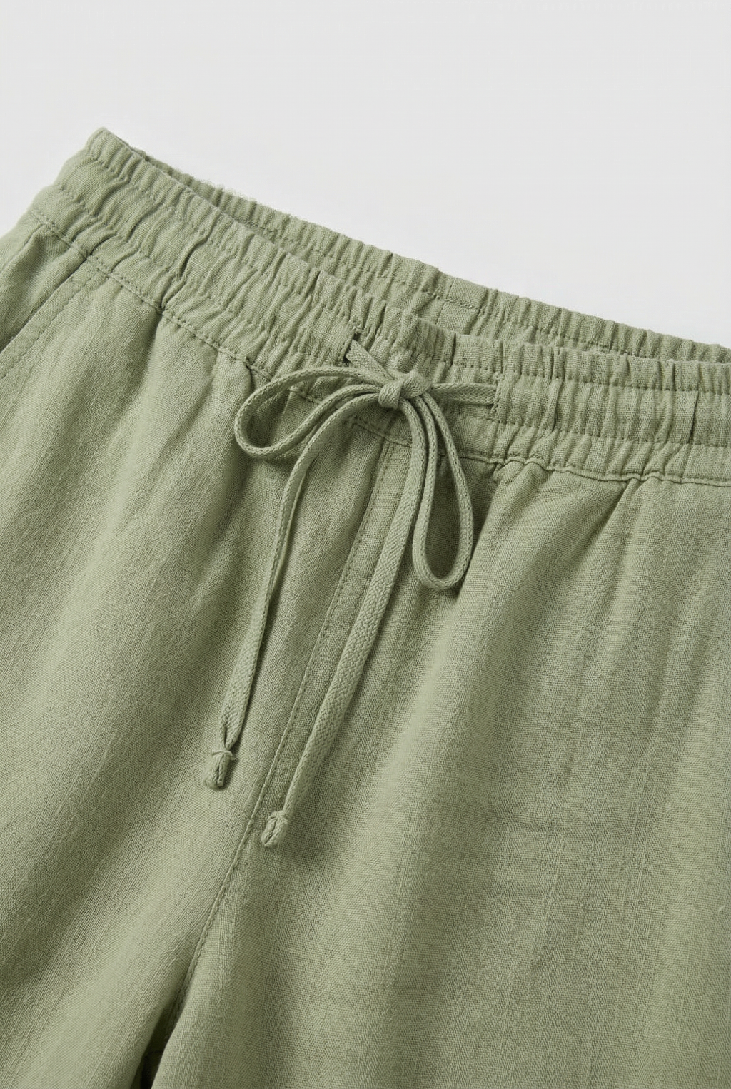Women's high waist linen-look trousers, close-up of drawstring waist detail