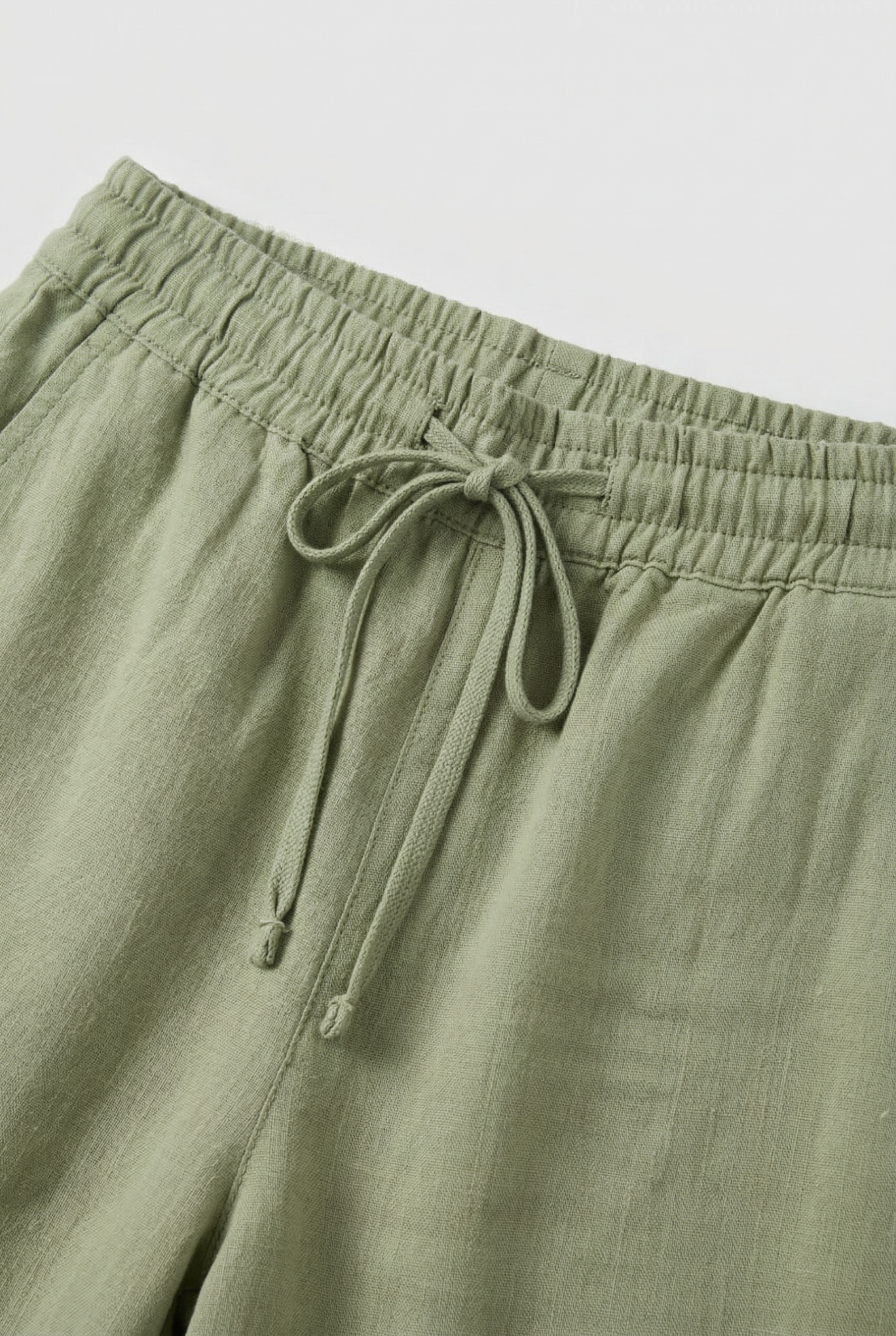 Women's high waist linen-look trousers, close-up of drawstring waist detail