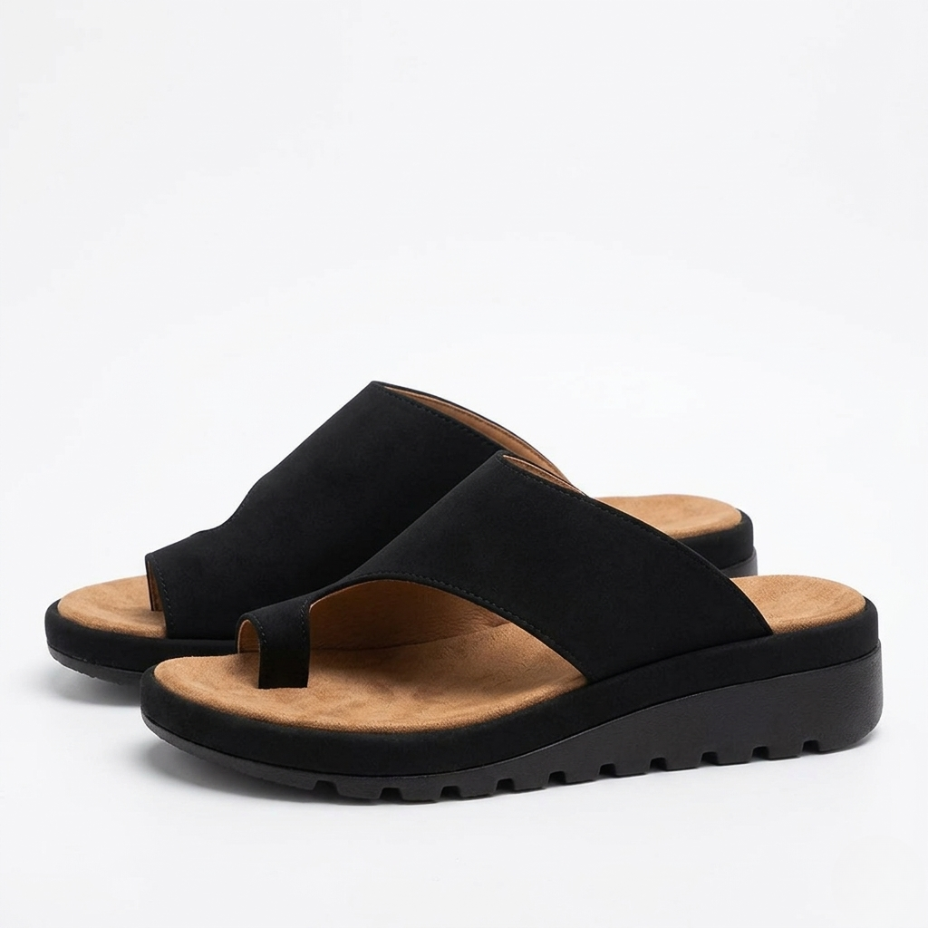 Women's toe ring slide sandals showing cushioned wedge sole detail