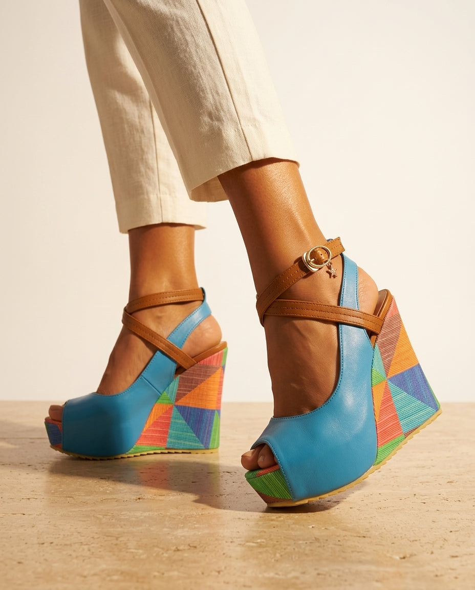 Blue Wedge Sandals, side view showing tan crisscross ankle strap and multicolour geometric wedge heel