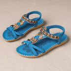 Bohemian pearl sandals on model at beach, summer styling shot