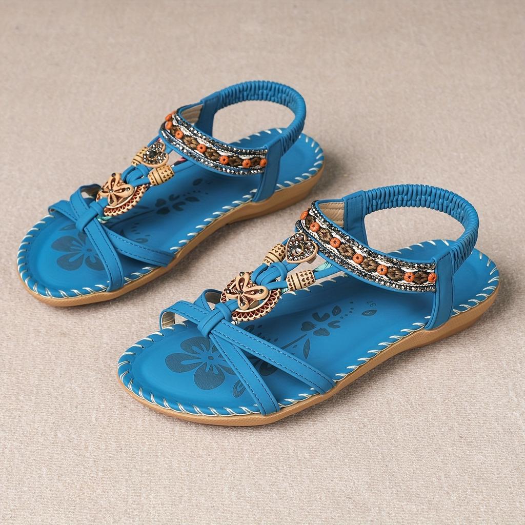 Bohemian pearl sandals on model at beach, summer styling shot