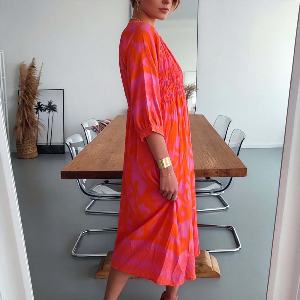 Vibrant pink print midi dress with shirred bodice and button front, side view