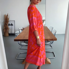 Vibrant pink print midi dress with shirred bodice and button front, side view