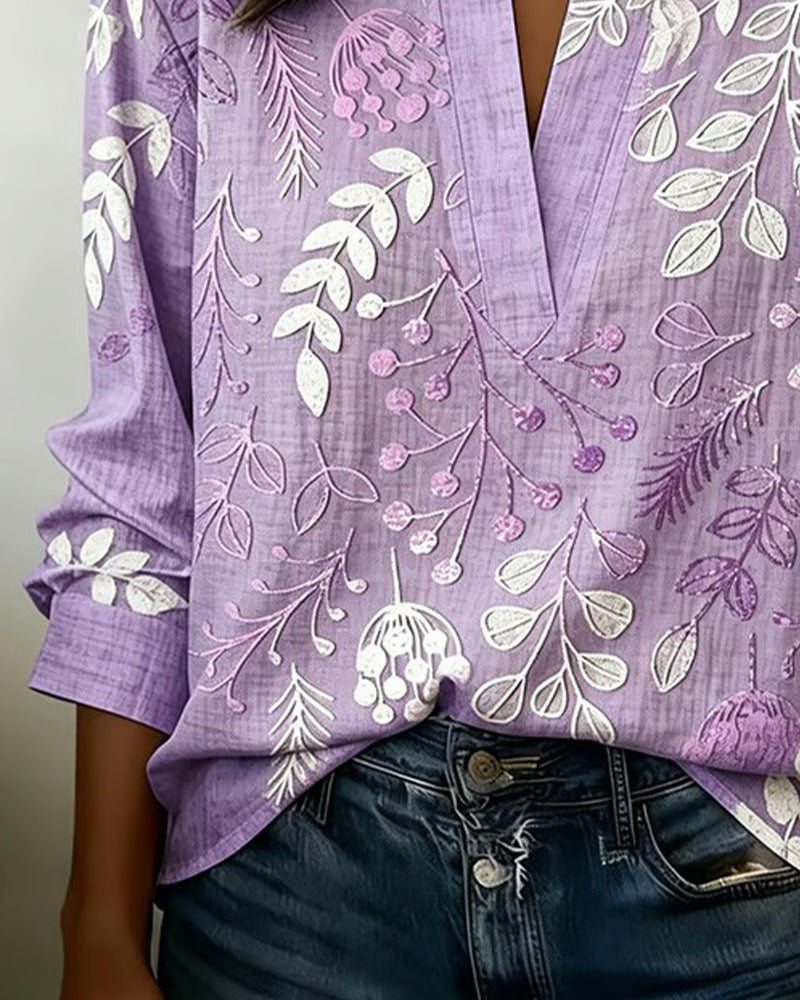 Women's floral high-neck blouse in blue, styled on model