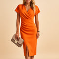 Women's wrap front V-neck midi dress in orange – side slit front view
