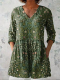 Floral print V-neck top with 3/4 sleeves in green, front view