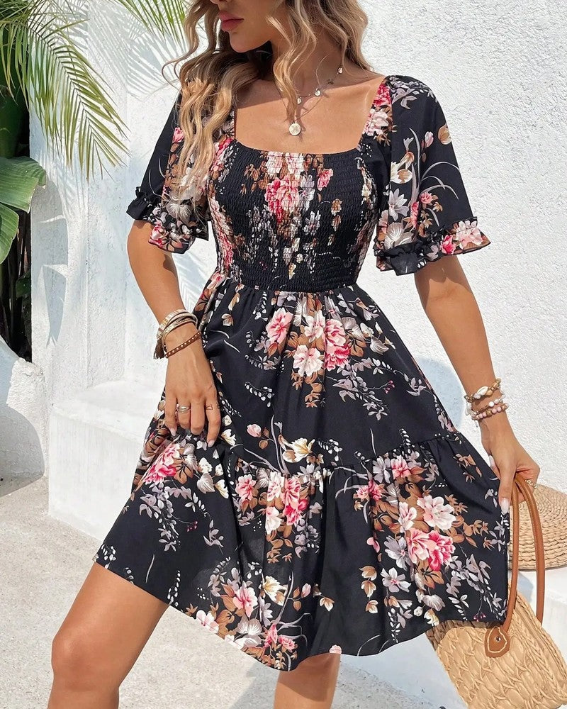Floral smocked mini dress in navy, styled on model