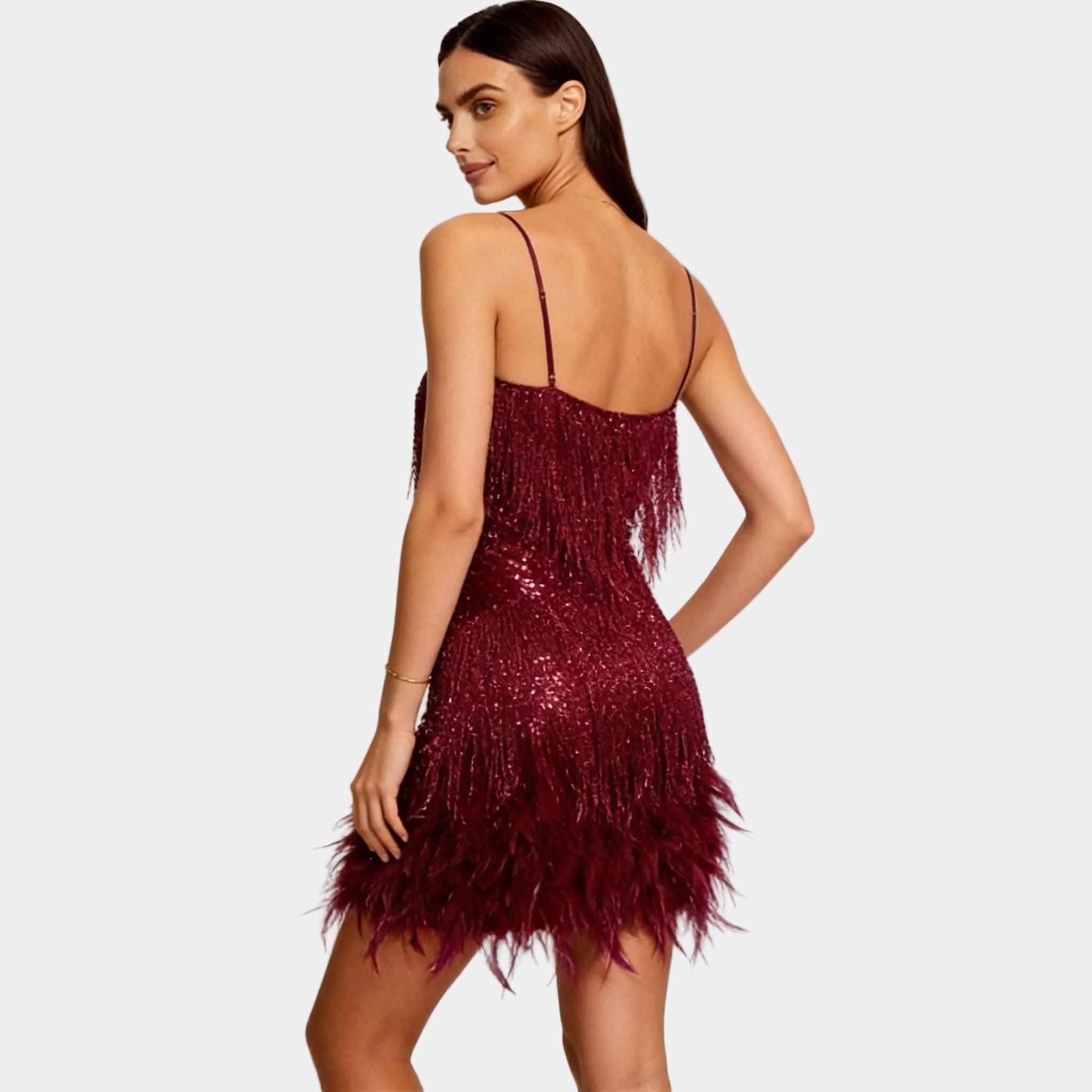 Women's burgundy sequin party dress with feather hem – angled view