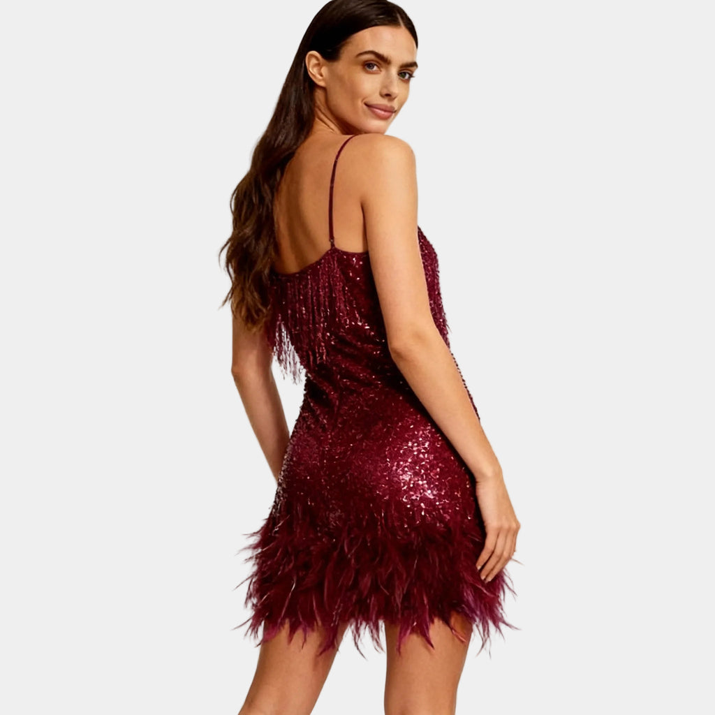 Women's burgundy sequin party dress with feather hem – back view