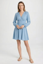 Women's lightweight pleated midi dress styled for an evening occasion