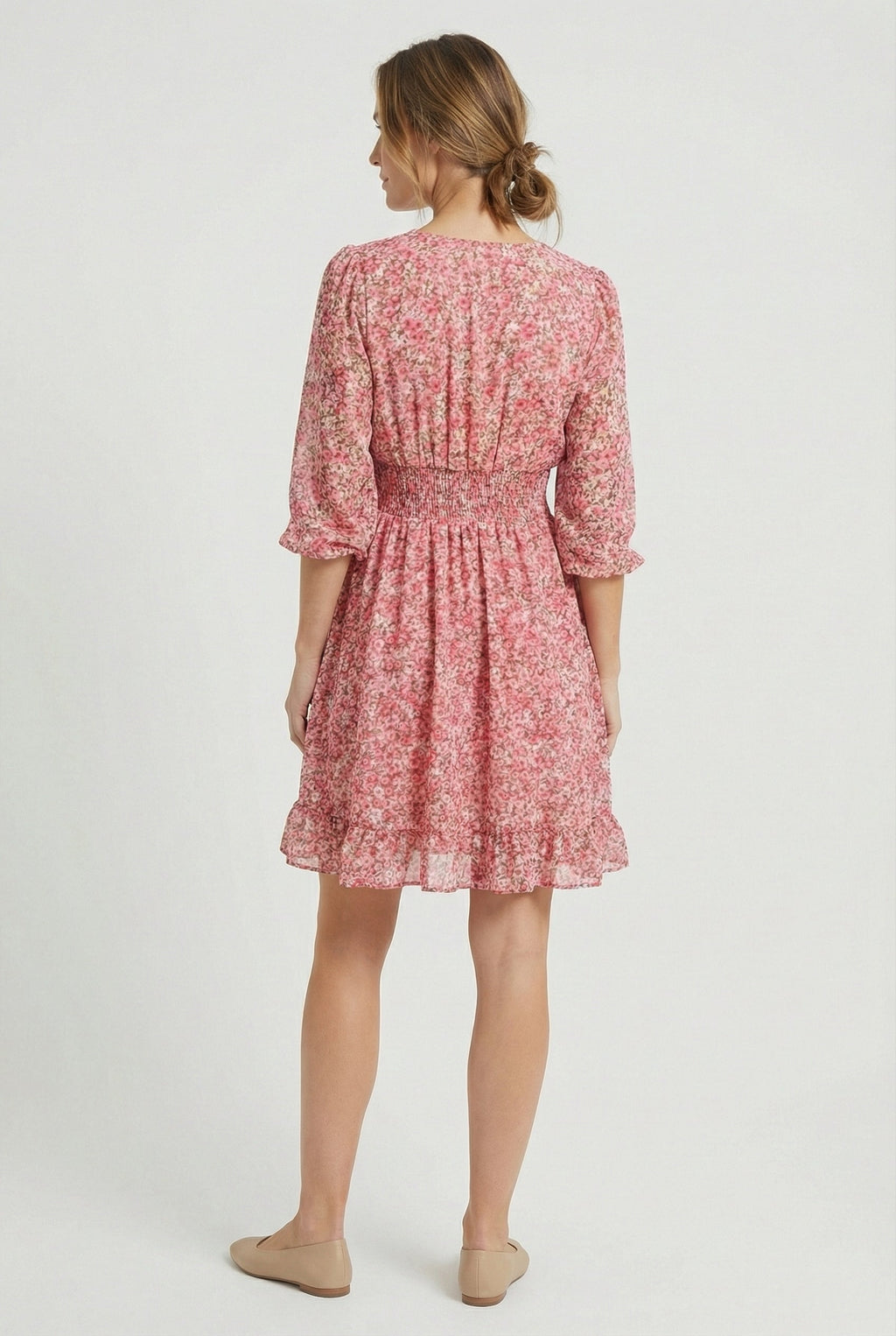 Women's silky mini dress with pleats, close-up of ruffle hem detail