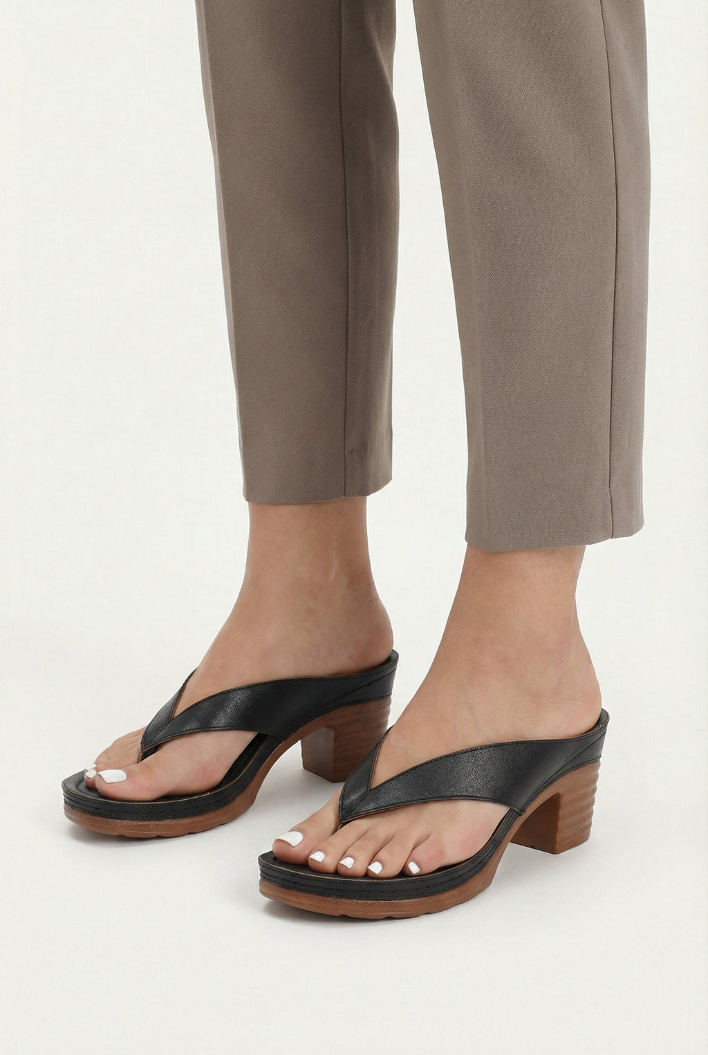 Women's vegan leather heel sandals styled with a dress, full length