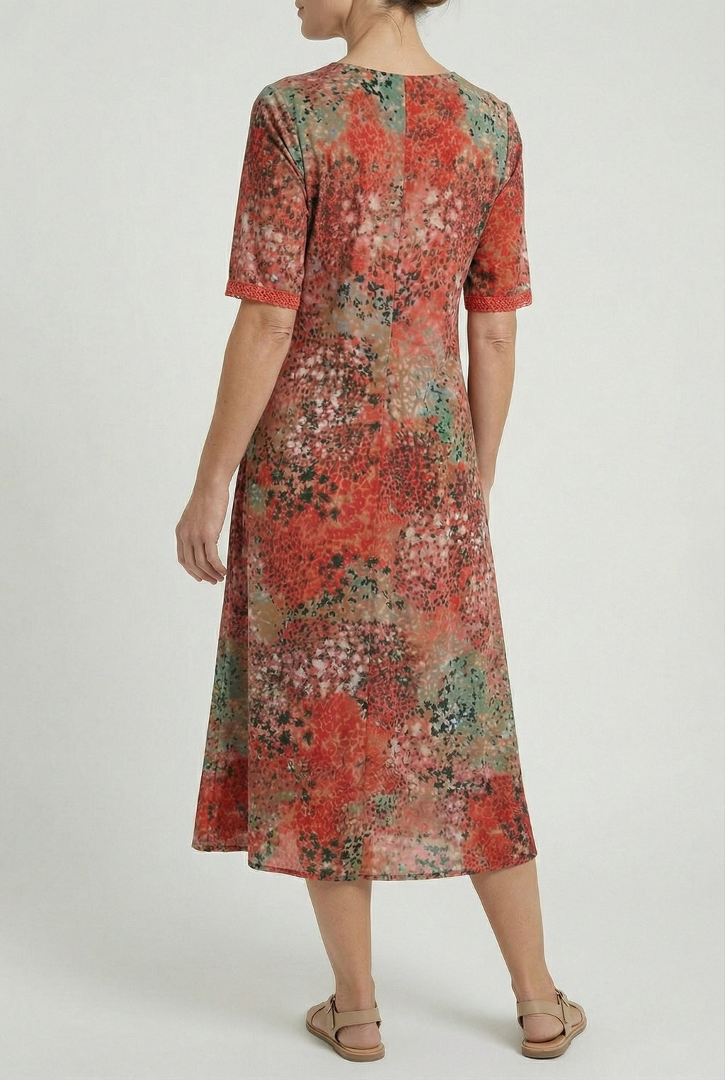 Women's flowy summer midi dress, close-up of abstract print