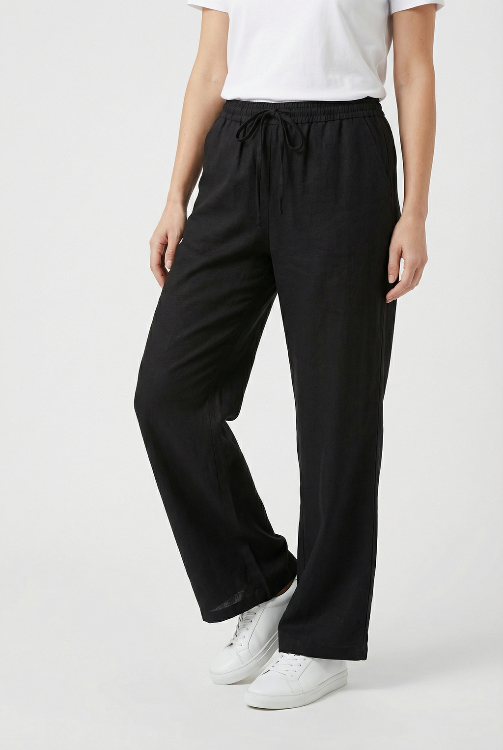 Women's relaxed linen trousers, fabric texture close-up