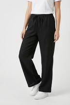 Women's relaxed linen trousers, fabric texture close-up