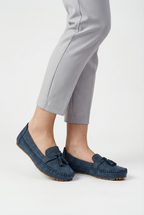 Women's fabric loafers styled with trousers, full length