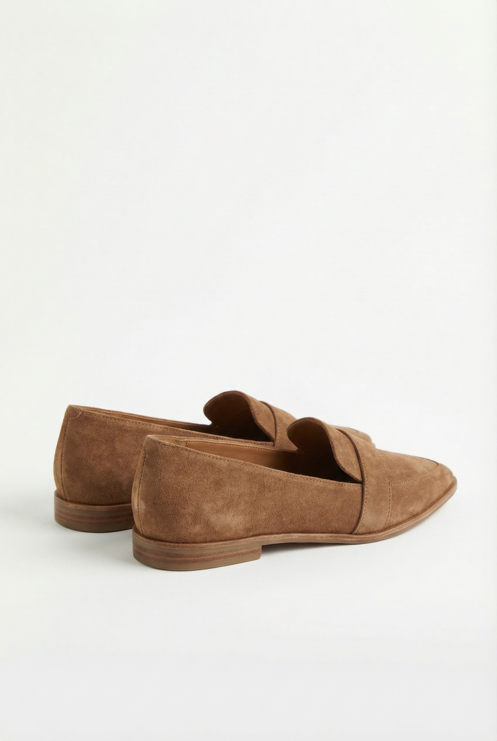 Women's cushioned loafers styled with trousers, full length