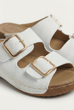 Women's lightweight wedge sandals styled with a dress, full length