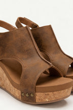 Women's platform wedge sandals styled with a smart outfit, full length