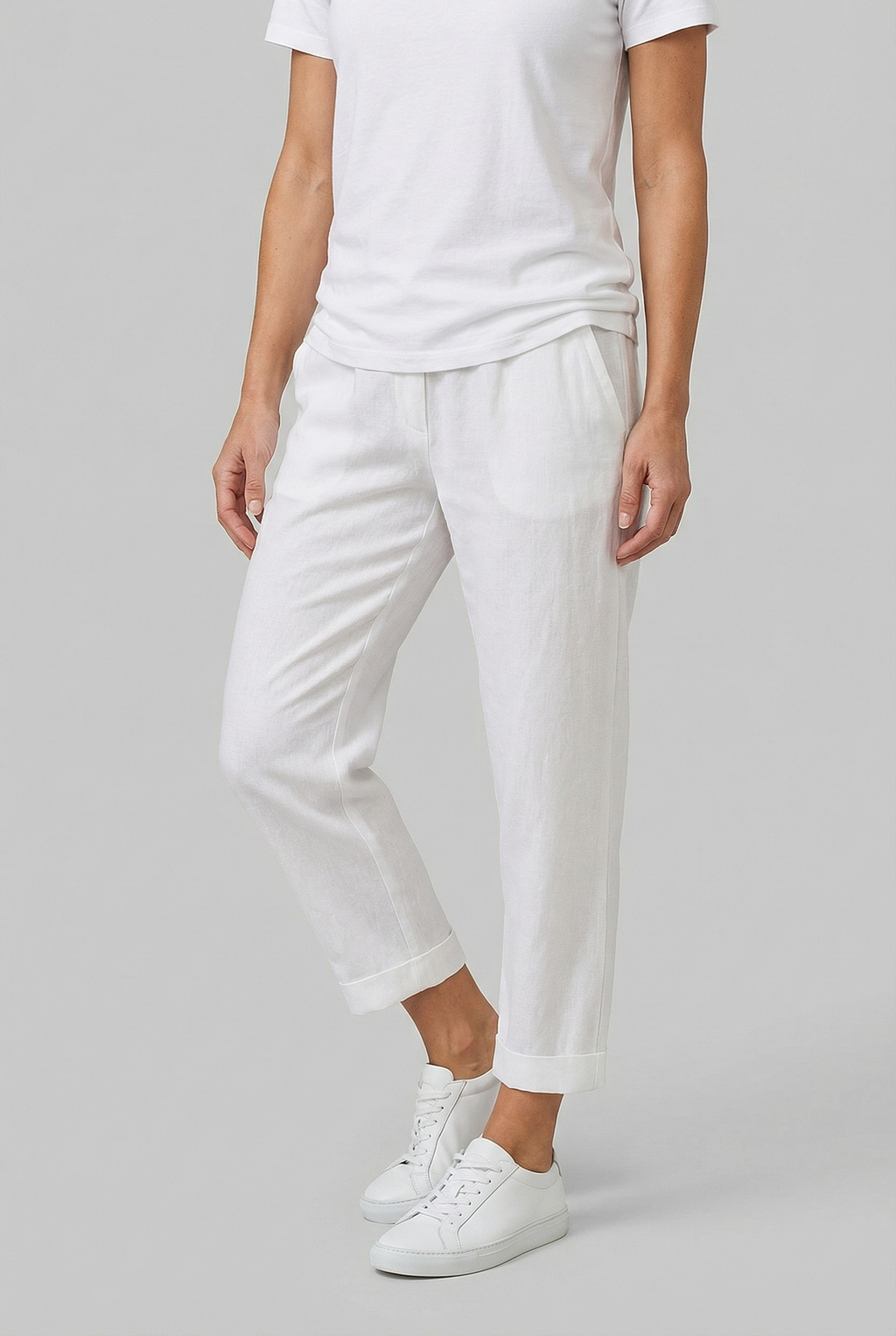 Women's relaxed fit linen trousers, side view showing straight-leg silhouette