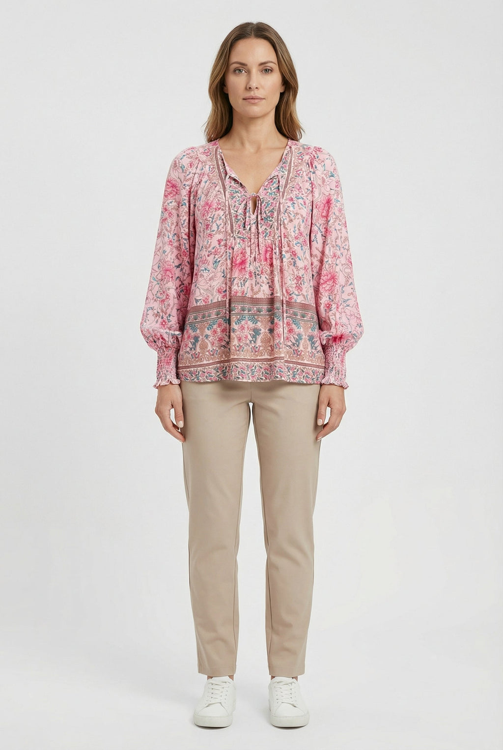 Women's classic top styled with trousers, full length view