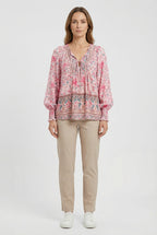 Women's classic top styled with trousers, full length view