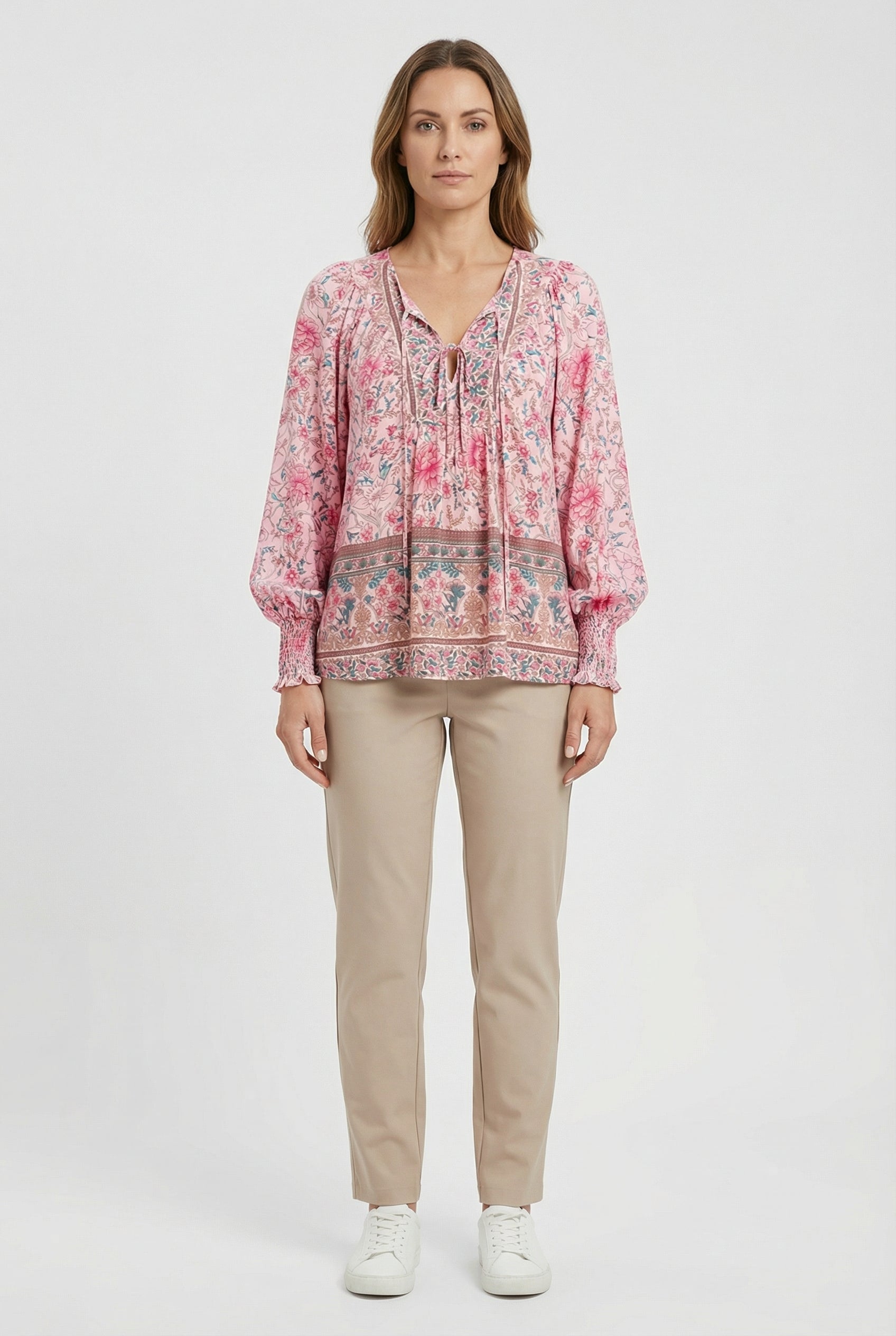 Women's classic top styled with trousers, full length view