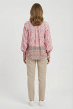 Women's relaxed fit top, close-up of neckline and fabric