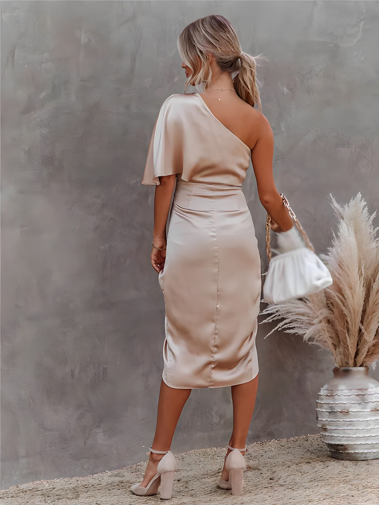 Women's satin midi dress styled with heels for formal events