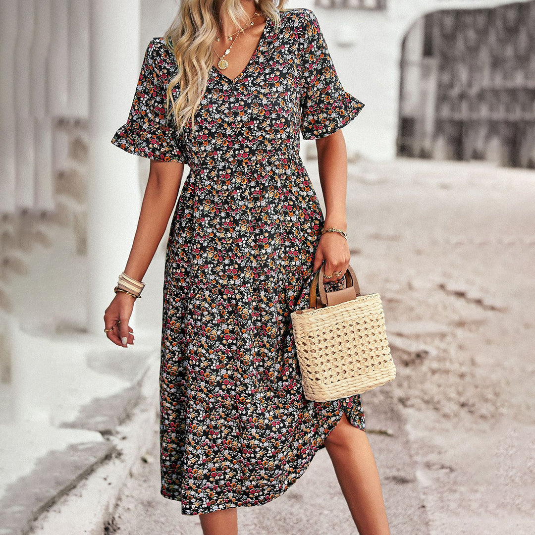 Ruffle sleeve floral midi dress showing flowing A-line skirt, side view