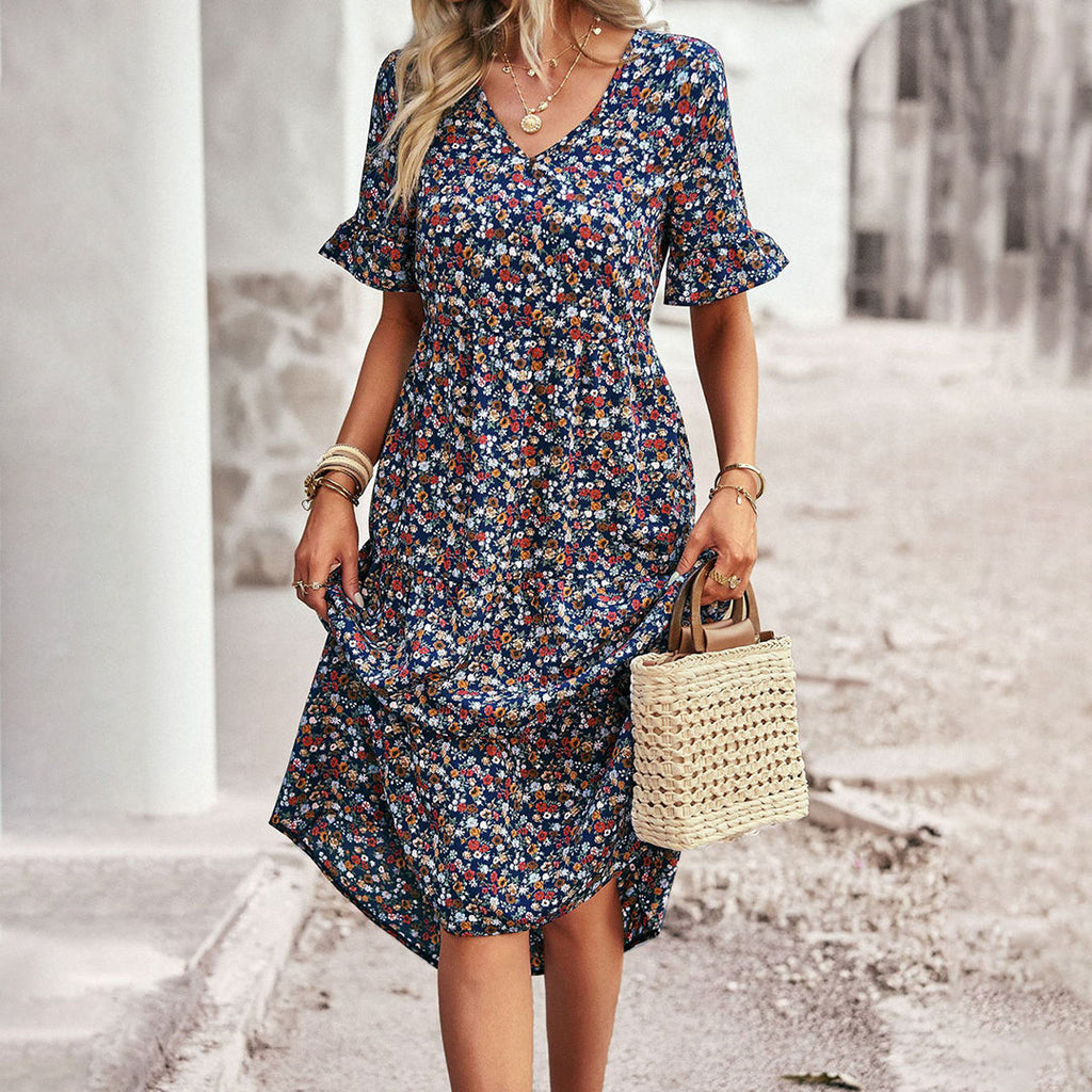 Close-up of ruffle sleeve and V-neckline on floral wedding guest midi dress