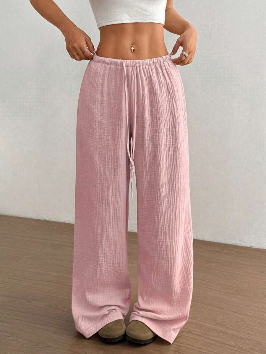 Pink wide-leg drawstring trousers, front view