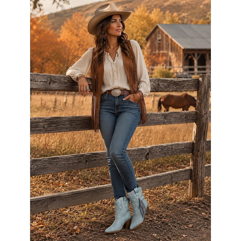 Blue Western Ankle Boots styled with jeans and fringe vest at a ranch fence