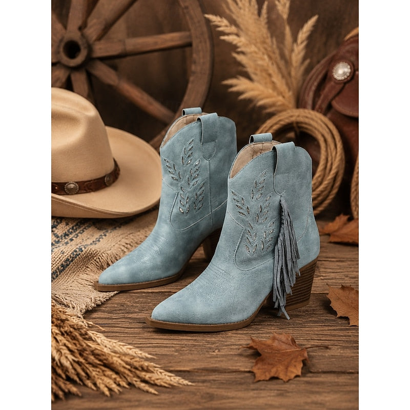 Blue Western Ankle Boots displayed with cowboy hat and rustic western props