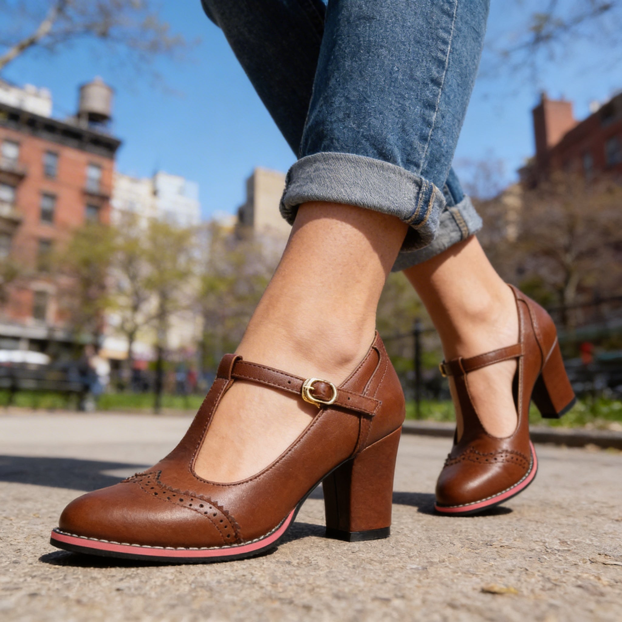 Brown T-strap brogue block heel Mary Jane shoes worn outdoors, side view