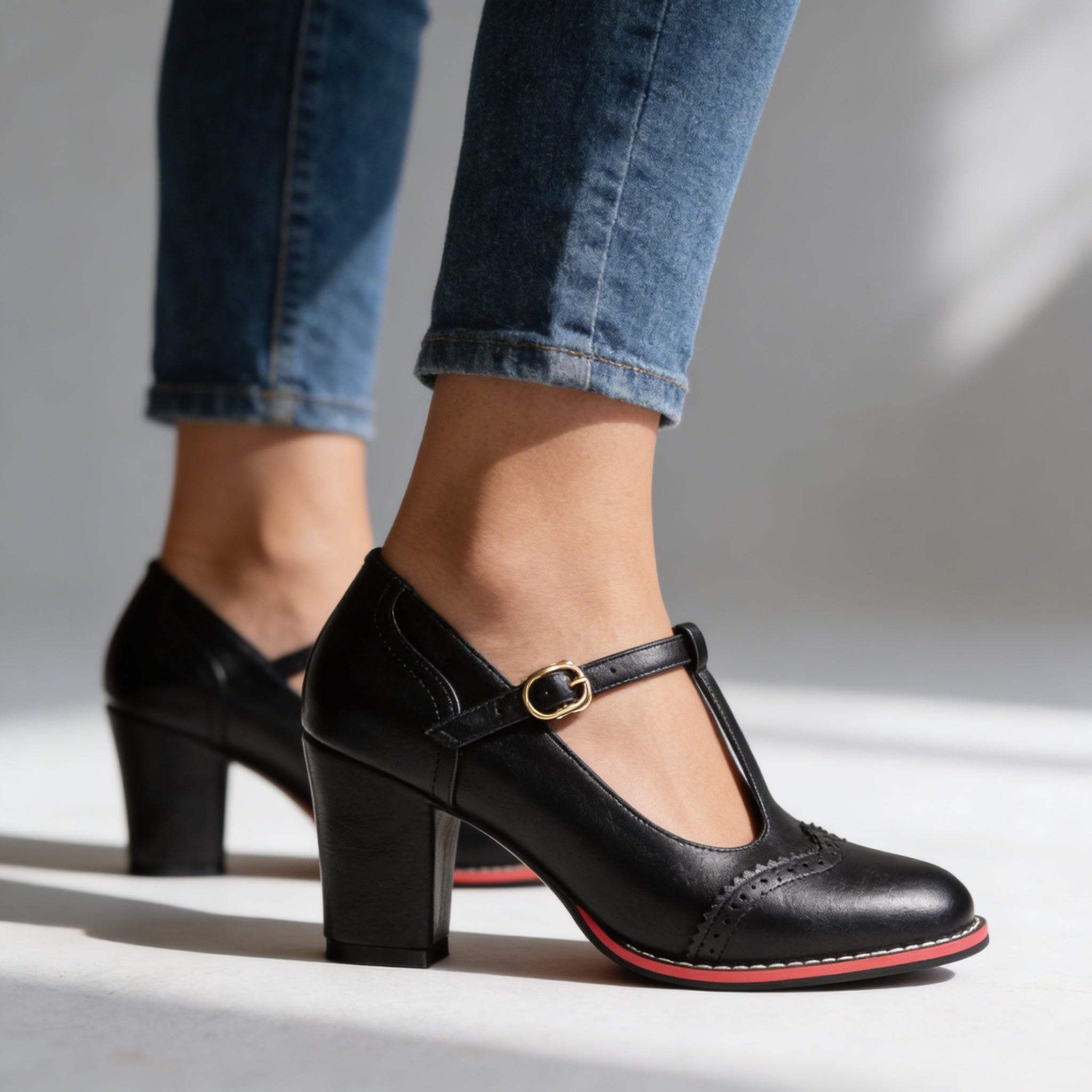 Black T-strap Mary Jane block heels close-up on model's feet outdoors