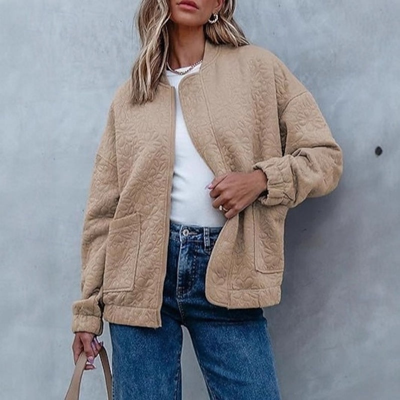 Khaki floral quilted bomber jacket, front view styled with jeans