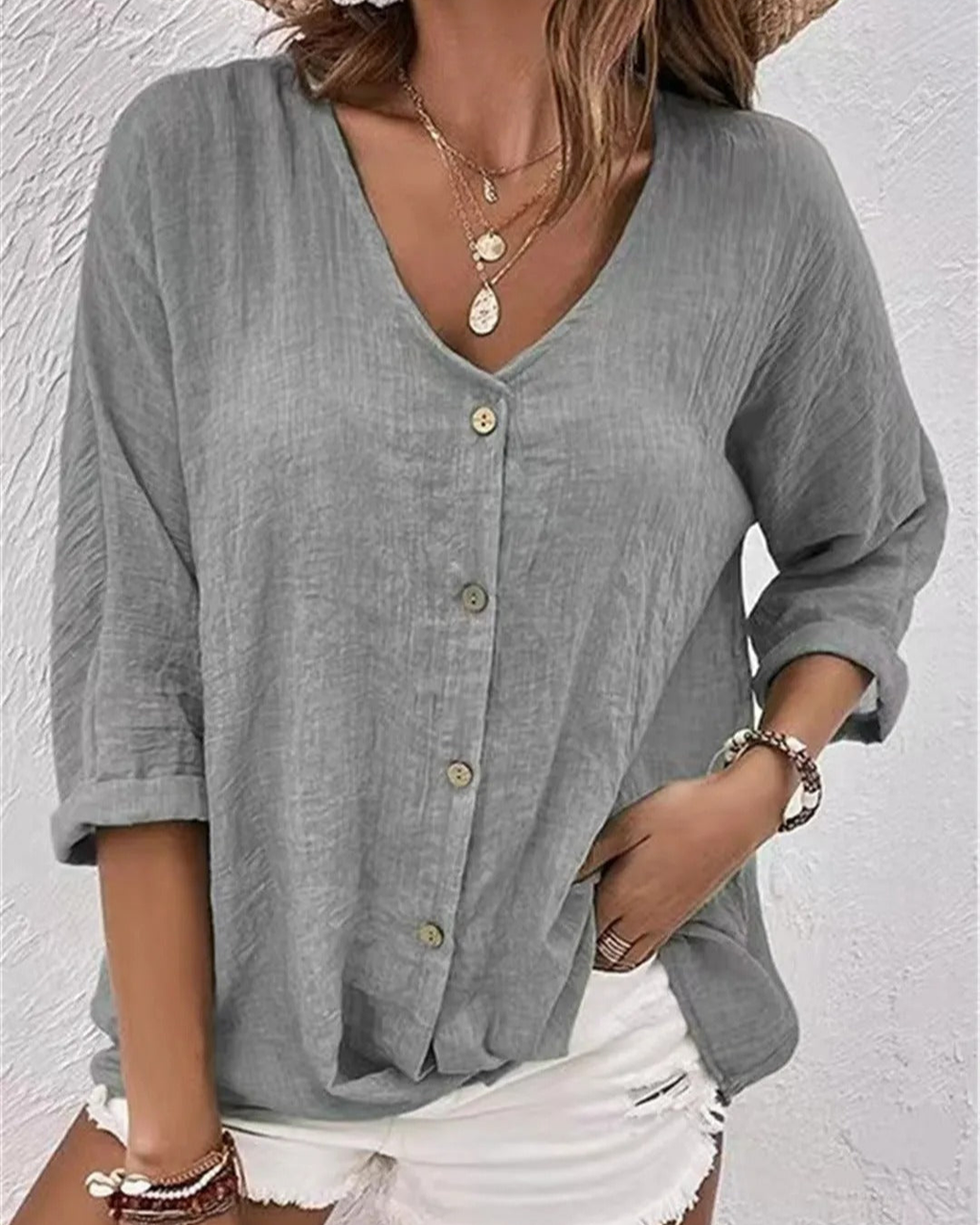 Deep V-neck button-down blouse in light blue, front view