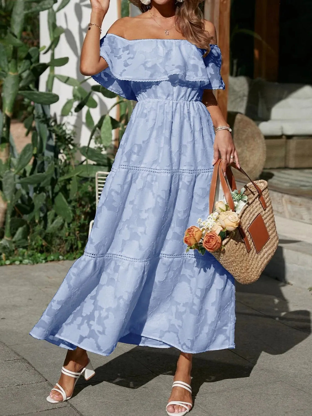 Women's elegant tiered maxi dress styled with heeled sandals