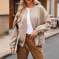 Khaki textured floral quilted bomber jacket, front view worn open with pockets